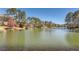 Picturesque lake view surrounded by lush trees, offering a serene and natural setting at 3045 Riviera Nw Dr, Conyers, GA 30012