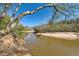 Scenic riverbank view with sandy edges surrounded by trees against a clear blue sky at 3045 Riviera Nw Dr, Conyers, GA 30012