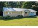 Charming brick home with a metal roof and well-maintained lawn at 401 Peggy Ln, Villa Rica, GA 30180