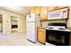 Kitchen with white appliances and wooden cabinets at 401 Peggy Ln, Villa Rica, GA 30180