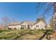 Back view of house featuring large yard at 7238 Hummingbird Ln, Winston, GA 30187