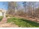 View of green and wooded backyard at 7238 Hummingbird Ln, Winston, GA 30187