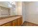 Bathroom with granite countertops, light wood cabinets, and a walk-in shower unit at 7238 Hummingbird Ln, Winston, GA 30187