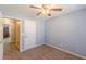 This carpeted bedroom features an open doorway and ceiling fan at 7238 Hummingbird Ln, Winston, GA 30187