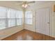 Eat-in kitchen with hardwood floors and natural light from the surrounding windows at 7238 Hummingbird Ln, Winston, GA 30187