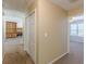 Hallway view with bi-fold closet doors looking into a room with a fireplace and sunlit windows at 7238 Hummingbird Ln, Winston, GA 30187