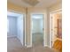 Hallway featuring doorways to carpeted rooms and a bathroom with brown floors and shower curtain at 7238 Hummingbird Ln, Winston, GA 30187