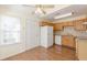Eat-in kitchen features wood cabinets, tile backsplash, and hardwood floors with an adjacent door at 7238 Hummingbird Ln, Winston, GA 30187