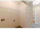 A practical laundry room with hookups and shelving with access to the bathroom at 7238 Hummingbird Ln, Winston, GA 30187