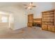 Comfortable living room with fireplace, ceiling fan, built-in bookshelves, and ample natural light at 7238 Hummingbird Ln, Winston, GA 30187