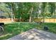 Large, grassy backyard with wooden fence and mature trees; an ideal place to play at 3003 Maple Ln, Alpharetta, GA 30009