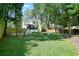 Expansive backyard features lush lawn, mature trees, patio, and an elevated deck perfect for outdoor living at 3003 Maple Ln, Alpharetta, GA 30009