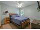 Comfortable bedroom featuring a ceiling fan, wood floors, and warm lighting at 3003 Maple Ln, Alpharetta, GA 30009