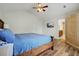 Bedroom with wood floors, ceiling fan, and television; features a closet and an ensuite bathroom at 3003 Maple Ln, Alpharetta, GA 30009