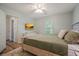 Bedroom features neutral colored wall, large bed, and view of the backyard at 3003 Maple Ln, Alpharetta, GA 30009