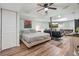 Basement bedroom featuring modern ceiling fan, hardwood floors, and an entertainment area with TV at 3003 Maple Ln, Alpharetta, GA 30009