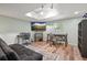 Basement living area featuring laminate floors, desk, and entertainment area with TV at 3003 Maple Ln, Alpharetta, GA 30009