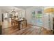 Charming dining room featuring hardwood floors, table with seating for six, and an open floorplan to the kitchen at 3003 Maple Ln, Alpharetta, GA 30009