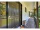 Welcoming front porch with dark wood railing, flower baskets, and a view of the front door at 3003 Maple Ln, Alpharetta, GA 30009