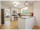 Bright, eat-in kitchen with white cabinets, stainless steel appliances, and granite countertops, offering modern convenience at 3003 Maple Ln, Alpharetta, GA 30009