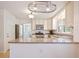 Well-appointed kitchen featuring stainless steel appliances, granite countertops, and an island with barstool seating at 3003 Maple Ln, Alpharetta, GA 30009