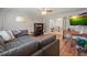 Inviting living room with hardwood floors and gray sofa, flowing into adjacent office at 3003 Maple Ln, Alpharetta, GA 30009