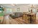 A cozy living area with hardwood floors, comfortable seating, and an adjacent dining space, perfect for relaxation at 3003 Maple Ln, Alpharetta, GA 30009