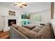 Relaxing living room with a sectional sofa, fireplace, and tv at 3003 Maple Ln, Alpharetta, GA 30009