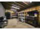 Storage room featuring unfinished ceilings, shelving units, work bench, and a refrigerator at 3003 Maple Ln, Alpharetta, GA 30009