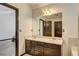Bathroom featuring double sinks, vanity with dark brown cabinets, and a large mirror at 375 Tambec Nw Trce, Lilburn, GA 30047