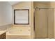 Relaxing bathroom features a soaking tub and a glass-enclosed shower at 375 Tambec Nw Trce, Lilburn, GA 30047