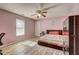 Warm pink bedroom with modern decor. This room has a large window and hardwood floors at 375 Tambec Nw Trce, Lilburn, GA 30047