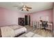 Stylish bedroom with modern décor, featuring a comfortable bed and study desk, creating a relaxing retreat at 375 Tambec Nw Trce, Lilburn, GA 30047