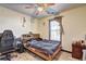 Bedroom features a modern bed, desk, wood-look flooring, and a bright window at 375 Tambec Nw Trce, Lilburn, GA 30047