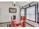 Bright dining room with a glass table, red chairs, and two large windows at 375 Tambec Nw Trce, Lilburn, GA 30047