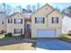Charming two-story home featuring a well-maintained front yard and a two-car garage at 375 Tambec Nw Trce, Lilburn, GA 30047