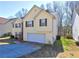 Charming two-story home with attached garage, landscaped yard, and inviting curb appeal at 375 Tambec Nw Trce, Lilburn, GA 30047