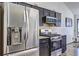 Updated kitchen featuring stainless steel appliances and dark cabinets with granite countertops at 375 Tambec Nw Trce, Lilburn, GA 30047