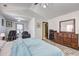 Large main bedroom with wood-look floors, a ceiling fan, and a seating area with two chairs at 375 Tambec Nw Trce, Lilburn, GA 30047