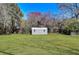 Spacious, well-maintained backyard featuring a detached storage shed with windows at 4212 Logan Dr, Loganville, GA 30052