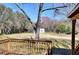 Wooden deck overlooking a spacious backyard with a shed and mature trees at 4212 Logan Dr, Loganville, GA 30052