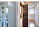 Half bath adjacent to laundry area with hardwood flooring at 4212 Logan Dr, Loganville, GA 30052