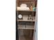 Linen closet with shelves and storage bins, featuring towels and personal care items at 4212 Logan Dr, Loganville, GA 30052