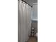 Bathroom showcasing a decorative shower curtain with a window and blinds at 4212 Logan Dr, Loganville, GA 30052