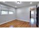 Bright bedroom with hardwood floors and a view into the hallway at 4212 Logan Dr, Loganville, GA 30052