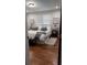 Well-lit bedroom with hardwood floors, stylish decor, and a comfortable bed at 4212 Logan Dr, Loganville, GA 30052