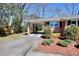 Attached carport with red mulch landscaping and convenient driveway access at 4212 Logan Dr, Loganville, GA 30052
