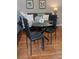 Cozy dining area with a glass-top table, black chairs, and modern artwork at 4212 Logan Dr, Loganville, GA 30052