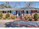 Charming brick home with black shutters, tidy landscaping, and a well-kept lawn at 4212 Logan Dr, Loganville, GA 30052