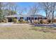 Charming brick home featuring a covered carport and beautifully landscaped front yard at 4212 Logan Dr, Loganville, GA 30052